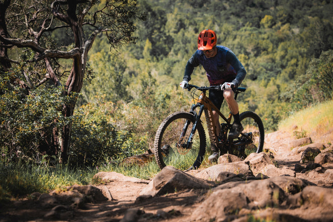 Man rides bike uphill and round corner