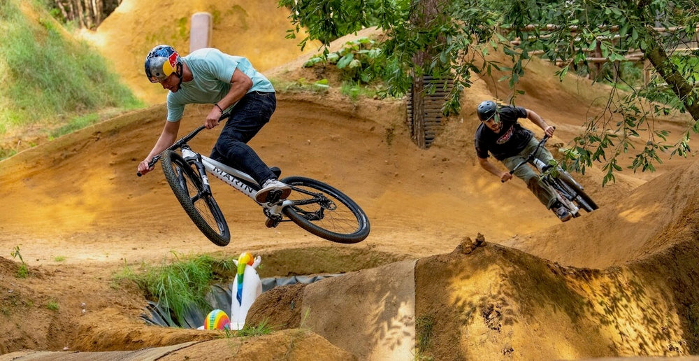 Marin sponsored rider Matt Jones riding a Marin Alcatraz dirt jump bike followed by another rider also riding a Marin Alcatraz on some mountain bike dirt jumps
