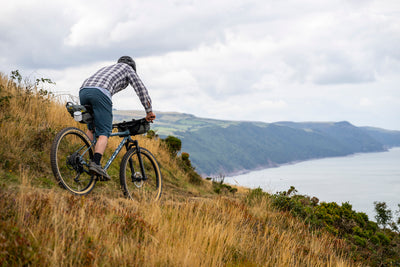 Man bikepacking on a coastal trail