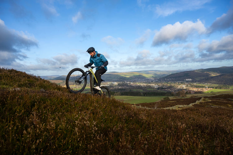 Duncan Shaw riding an ebike uphill in scotland