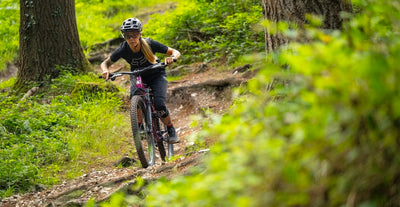 Marin rider Juliet Elliott riding a Rift Zone XR AXS on a trail in the forest, UK.