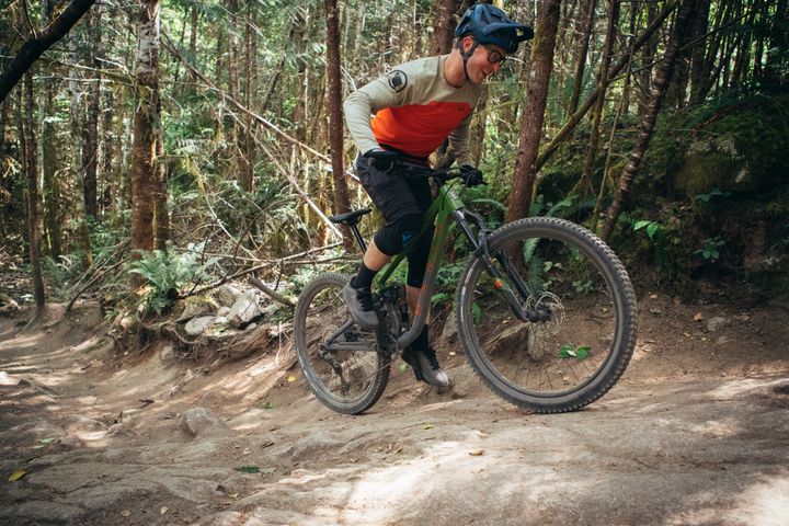 Man rides a bike uphill off road