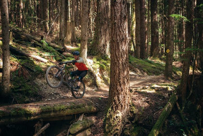 Man wheelies along a trail