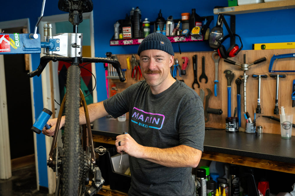 man in workshop smiling at the camera