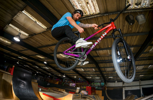 red and purple dirt bike being ridden 