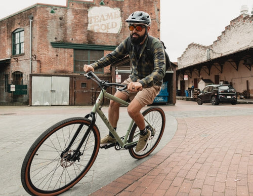 Man rides a bike in an urban location