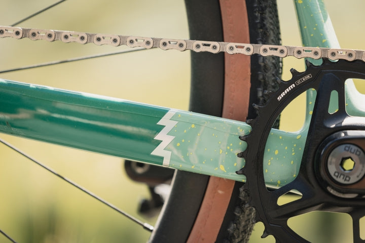 Close-up of a bicycle chain and gear system with a blurred background