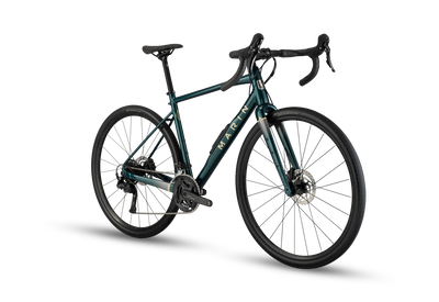 A gravel bicycle with a dark teal-green frame, black handlebars, and black wheels, shown from a three-quarters angle on a white background with a soft shadow.