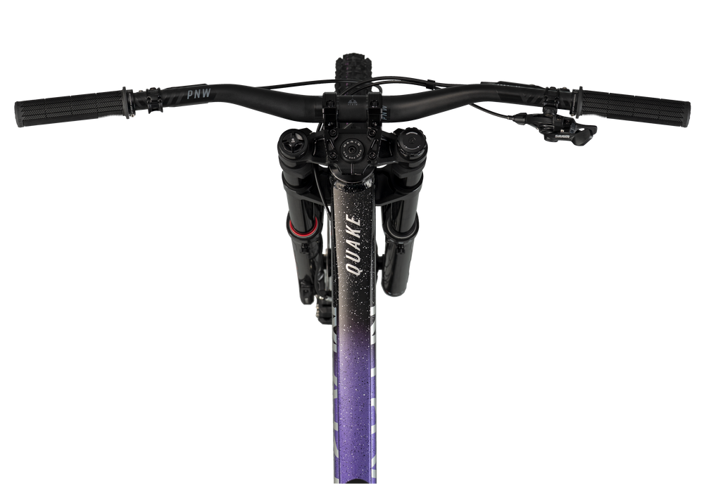 Close-up of a bicycle handlebar with 'Quake' branding on a white background