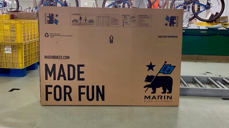 A Marin Bikes cardboard bike box in a warehouse
