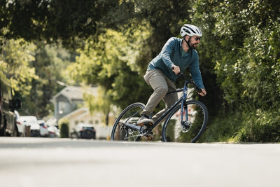 Man rides along a suburban road