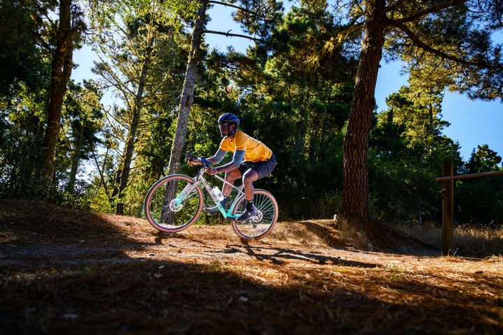 Man riding a dropbar bike on a woodland trail