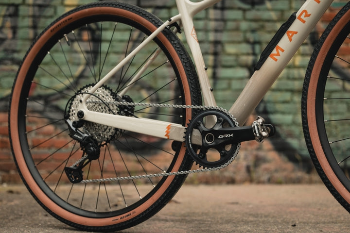 Close-up of a bicycle chain and gear system with a blurred background