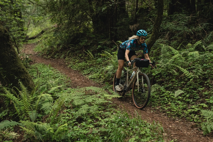 Person riding a bicycle on a forest trail