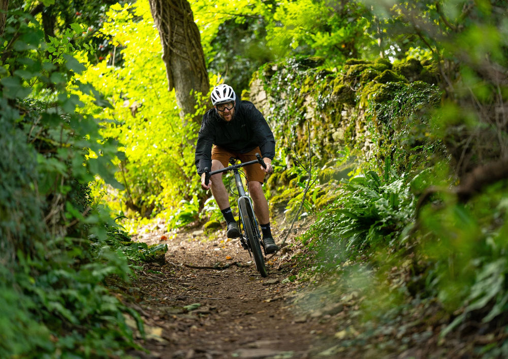 Man rides Marin lombard down trail surrounded in green