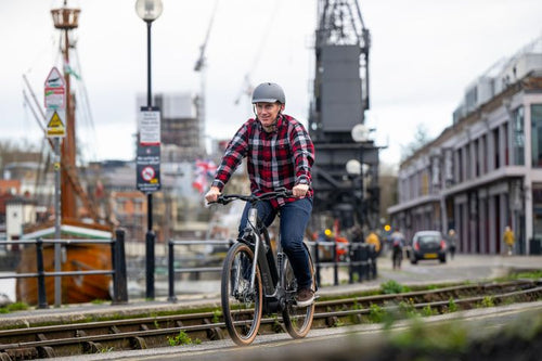 Man rides a bike in an urban location