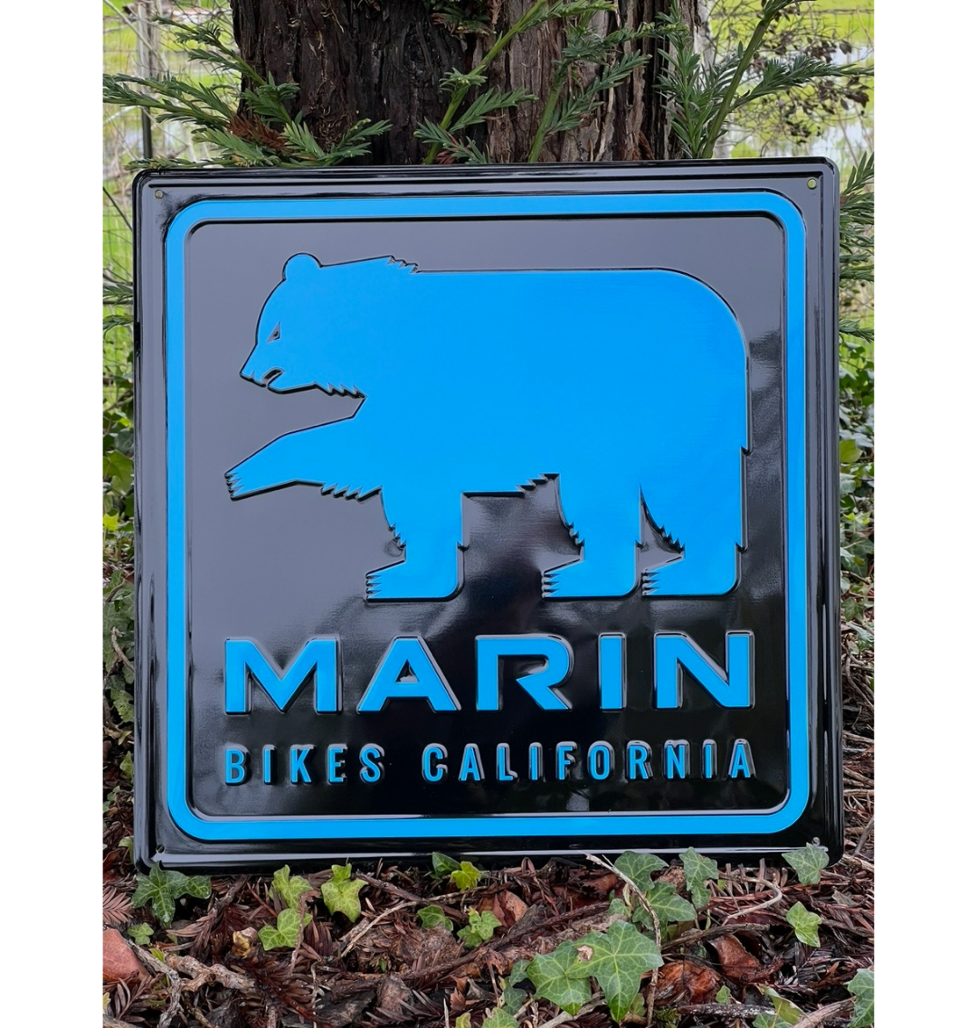 blue bear graphic on black sign