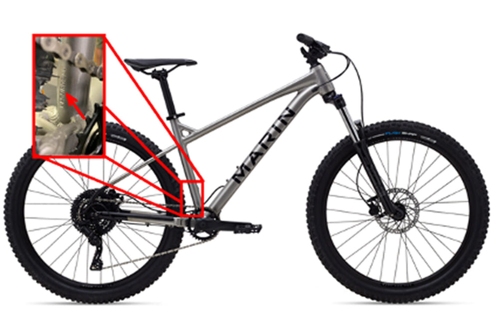 An image of a 2021 Marin Bikes San Quentin mountain bike painted in silver with an exploded section of the image to show where the frame's serial number is located