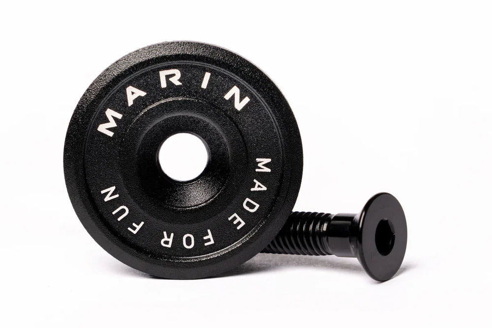 A black Marin Bikes stem top cap