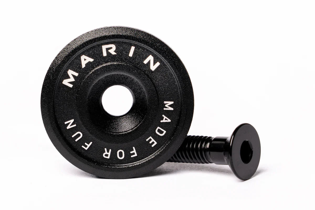 A black Marin Bikes stem top cap