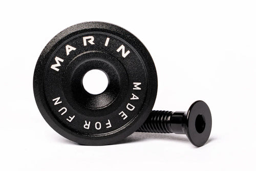 A black Marin Bikes stem top cap