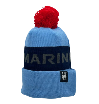 A blue and black Marin Bikes bobble hat, with a red bobble