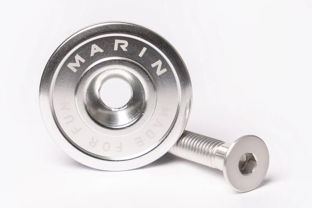 A silver Marin Bikes stem top cap